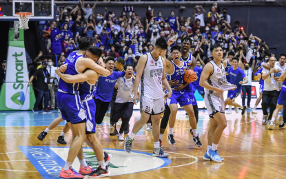 <p><strong>CHAMPION AGAIN.</strong> The Ateneo Blue Eagles celebrate after beating the defending champion UP Fighting Maroons, 75-68, in the deciding Game 3 of their UAAP men’s basketball title at the Smart Araneta Coliseum in Quezon City on Monday night (Dec. 19, 2022). It was Ateneo’s 12th title since joining the league in 1977.<em> (Photo courtesy of the UAAP Season 85 Media Team)</em></p>