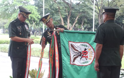 <p><strong>CAMPAIGN STREAMERS.</strong> Lt. Gen. Bartolome Vicente Bacarro (center), the Armed Forces of the Philippines (AFP) chief of staff, awards the six campaign streamers to the Army's 10th Infantry "Agila" Division (10ID), received by Maj. Gen. Nolasco Mempin (right), commander of the 10ID, during the 87th AFP Founding Anniversary Recognition Ceremony at GHQ Canopy, Camp Aguinaldo, Quezon City on Wednesday (Dec. 21, 2022). Campaign Streamer awards are given to military units instrumental in the dismantling of the communist guerilla fronts.<em> (Photo from 10ID)</em></p>