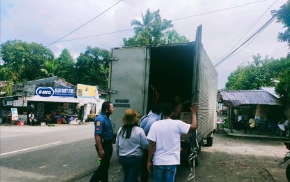 <p><strong>CHECKPOINT.</strong> Personnel of the Antique Provincial Veterinary (ProVet) Office and the local police check a cargo van in line with the intensified implementation of a ban on pork and other pork-based products.  The provincial government said Wednesday (Dec. 21, 2022) there would be no letup in guarding the borders against African Swine Fever (ASF).  <em>(PNA photo courtesy of Antique ProVet)</em></p>