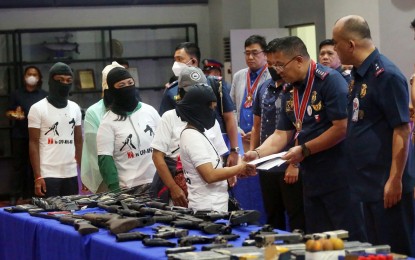 <p><strong>NO TURNING BACK.</strong> Philippine National Police chief Gen. Rodolfo Azurin Jr. hands over government assistance to former New People’s Army rebels at the National Capital Region Police headquarters in Camp Bagong Diwa, Taguig City on Monday (Dec. 26, 2022). On the day of the 54th founding anniversary of the Communist Party of the Philippines, the police highlighted how members of communist groups are realizing the futility of their violent ways. <em>(PNA photo by Avito Dalan)</em></p>