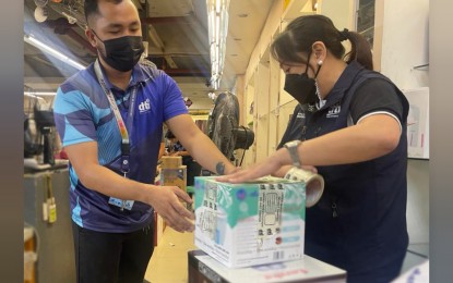 <p><strong>UNCERTIFIED GOODS</strong>. Trade Undersecretary Ruth Castelo seals a box of uncertified appliance during a market monitoring of the Department of Trade and Industry’s Fair Trade Enforcement Bureau last Dec. 16, 2022 in a retail establishment in Manila. For the first 11 months of the year, the DTI confiscated some PHP64 million worth of uncertified products in the country. <em>(Photo courtesy of DTI)</em></p>