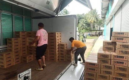 <p><strong>FOOD AID.</strong> Personnel from the Department of Social Welfare and Development in Davao Region (DSWD -11) hauls the food packs on Tuesday (Dec. 27, 2022), set to be delivered to Iligan City on Wednesday. The agency prepared 5,000 family food packs for families affected by shear line-induced rains in Region 10. <em>(Photo courtesy of DSWD-11)</em></p>