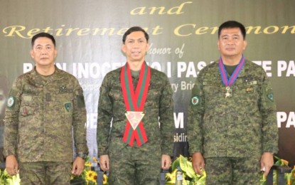 <p><strong>TURNOVER OF COMMAND</strong>. Maj. Gen. Benedict Arevalo (center), commander of the 3rd Infantry Division and acting commander of the Visayas Command, with Brig. Gen. Inocencio Pasaporte (right) and Col. Michael Samson during the change of command of the 303rd Infantry Brigade at Camp Gerona, Murcia, Negros Occidental on Tuesday (Dec. 27, 2022). Samson was designated as acting brigade commander to succeed Pasaporte, who retired from military service. <em>(Photo courtesy of 303rd Infantry Brigade, Philippine Army)</em></p>