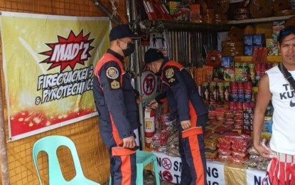 <p><strong>INSPECTION</strong>. Personnel of the Bureau of Fire Protection (BFP) in Bacolod City inspect a firecracker stall at the Reclamation Area on Dec. 27, 2022. Based on the BFP list, 46 locations have been designated as community fireworks display areas and firecracker zones in the city to welcome the New Year. <em>(Photo courtesy of BFP-Bacolod City Rodriguez Fire Sub-Station)</em></p>