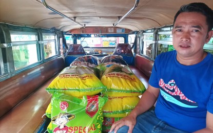 <p><strong>NEW ENTREPRENEUR</strong>. A displaced transport worker in Central Luzon shows the rice retailing package he received under the government's “EnTSUPERneur” program on Dec. 28, 2022. The program aims to provide alternative sources of income to public transport drivers affected by the pandemic and the Public Utility Vehicle Modernization Program. <em>(Photo courtesy of LTFRB Region 3)</em></p>