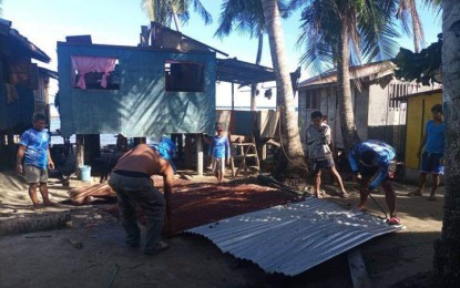 <p><strong>REBUILDING HOMES</strong>. Residents of Tumalutab Island in Zamboanga City on Monday (Jan. 2, 2023) help one another fix houses that were destroyed by extreme weather conditions. Heavy downpour and strong winds destroyed at least 10 houses in Sitios Look and Pitas Sunday (Jan. 1) night. <em>(Photo courtesy of Usnaira Abunawas, Tumalutab barangay information officer)</em></p>
