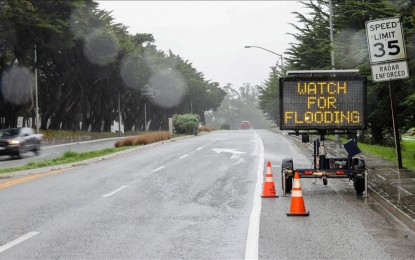 <p>A warning road sign is seen on the highway 92 West in Half Moon Bay as heavy rainstorm hits West Coast of California, United States on December 31, 2022. <em>(Tayfun Coskun - Anadolu Agency)</em></p>