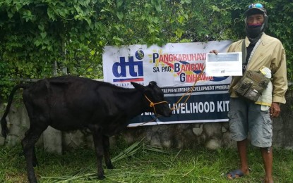 <p><strong>LIVELIHOOD AID.</strong> A beneficiary receives a young cow as livelihood assistance from the Department of Trade and Industry (DTI) for "persons in distress." The DTI in Negros Oriental province was able to distribute more than PHP20.6 million in livelihood kits to 2,607 recipients in 2022. <em>(Photo courtesy of the DTI-Negros Oriental Facebook page)</em></p>