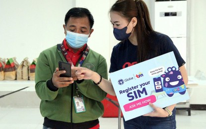 <p>A telco representative answers a question from a media person about SIM card registration at the sidelines of a press briefing at the NTC in Quezon City on Friday (Jan. 6, 2023).<em> (PNA photo by Robert Oswald Alfiler)</em></p>