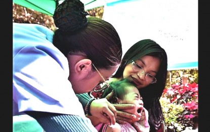 <p><strong>VAX-PREVENTABLE DISEASES</strong>. A nurse administers an anti-measles vaccine to a toddler during the synchronized national vaccination in Baguio City in this undated photo. The Department of Health continues to convince parents and guardians of children who had refused or deferred the vaccination of their children for various reasons, to bring the kids to health centers for inoculation. <em>(PNA file photo)</em></p>