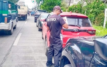 <p><strong>ILLEGAL PARKING.</strong> Personnel of the Public Safety Transportation Management Office (PSTMO) issues citation tickets to illegally parked vehicles in Iloilo City in this undated photo. The PSTMO will tow illegally parked vehicles to clear roads of obstructions. <em>(Photo courtesy of PSTMO) </em></p>