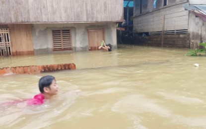 <p><strong>DELUGE.</strong> A man in Jipapad town, Eastern Samar province wades through chest-deep flood waters Thursday (Jan. 12, 2023). According to the Office of Civil Defense, widespread flooding in Eastern Visayas region due to heavy rains has left two persons dead and displaced at least 213,737 residents. <em>(Photo courtesy of Jipapad Mayor Benjamin Ver)</em></p>