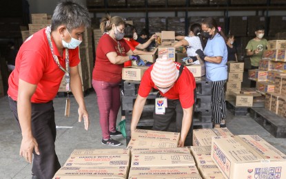 <p><strong>RELIEF HUB.</strong> Volunteers prepare relief goods at the Department of Social Welfare and Development (DSWD) National Resource Operations Center in Pasay City on Jan. 12, 2023 for flood victims in the Visayas and Mindanao. DSWD Secretary Rex Gatchalian on Thursday (Oct. 5, 2023) assured that the agency is making the necessary changes to improve the stockpiling, cleanliness, and condition of the facility. <em>(PNA photo by Yancy Lim)</em></p>