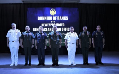 <p><strong>PROMOTED.</strong> AFP chief Gen. Andres Centino (center) leads the donning rites for three key officials of the military in Camp Aguinaldo, Quezon City on Thursday (Jan. 12, 2023). Promoted to the rank of Lieutenant General were AFP vice chief of staff, Maj. Gen Arthur M. Cordura (3rd from left), and Southern Luzon Command chief, Maj. Gen. Efren P. Baluyot (2nd from left), while promoted to the rank of Vice Admiral was Navy flag officer-in-command Rear Adm. Toribio Adaci Jr. (3rd from right). <em>(Photo courtesy of AFP)</em></p>
