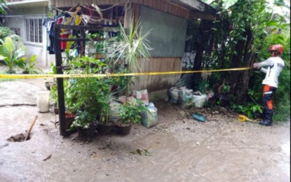 <p><strong>SINKHOLE.</strong> A member of the Disaster Risk Reduction and Management Office (DRRMO) of La Libertad, Negros Oriental monitors the area where a suspected sinkhole was discovered on Tuesday (Jan. 10, 2023). The sinkhole appears to be getting bigger, prompting the agency to request an inspection and assessment. <em>(Photo courtesy of the La Libertad DRRMO)</em></p>