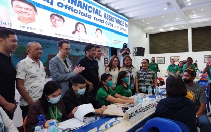 <p><strong>CASH AID</strong>. The first two beneficiaries (right) from the 1st district of Pangasinan of the cash amelioration from the provincial government. The distribution on Thursday (Jan. 12, 2023) in Alaminos City was attended by provincial government officials and Senator Allan Peter Cayetano (second from left). <em>(Photo by Hilda Austria)</em></p>