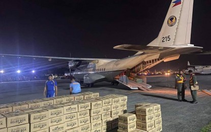 <p><strong>RELIEF AID.</strong> Air Force personnel account for relief goods unloaded from a C-295 medium transport aircraft of the Philippine Air Force (PAF) on Thursday (Jan. 12, 2023). The relief goods will be distributed to victims of floods in the Visayas and Mindanao. <em>(Photo courtesy of PAF)</em></p>