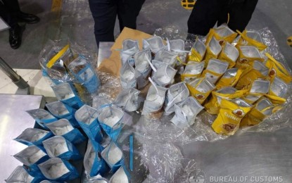 <p><strong>SNACKS OR DRUGS?</strong> Authorities arrest a consignee after intercepting a parcel containing shabu worth PHP89 million declared as snacks during a controlled delivery operation in Las Piñas City on Jan. 11, 2023. The package came from Nigeria. <em>(Photo from BOC-NAIA)</em></p>