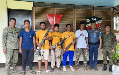 <p>PEACE. Five Abu Sayyaf bandits (2nd to 6th from left) surrender to government forces in Barangay Tumahubong, Sumisip town, Basilan province on Thursday (Jan. 12, 2023). The bandits, who also turned over three firearms and ammunition, said they want to reunite with their families. <em>(Courtesy of Area Police Command-Western Mindanao)</em></p>
