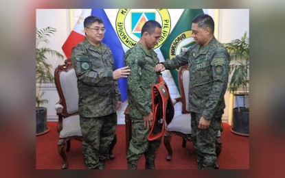 <p><strong>NEW RANK</strong>. Philippine Army chief, Lt. Gen. Romeo Brawner Jr. (right), pins the new rank on champion boxer Charly Suarez in a ceremony at the Army headquarters in Fort Bonifacio, Taguig City on Friday (Jan. 13, 2023). Suarez was promoted to Private First Class for his achievements last year.<em> (Photo courtesy of Philippine Army)</em></p>