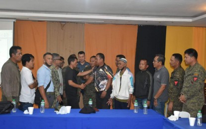 <p><strong>PEACE PACT.</strong> Commander Rajan Abdulrahman (in black shirt), deputy commander of the Moro Islamic Liberation Front’s (MILF) 114th Base Command, and Mohammad Juddihal Muddalan, chairperson of Barangay Parangbasak in Lamitan City, Basilan province, shake hands as they peacefully settle their dispute on Tuesday (Jan. 17, 2023). The dispute was resolved through the intercession of the Government of the Philippines-MILF-Moro National Liberation Front-Coordinating Committee on the Cessation of Hostilities. <em>(Photo courtesy of Western Mindanao Command)</em></p>