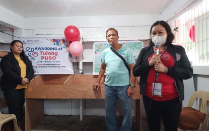 <p><strong>GOV'T AID.</strong> A representative from Overseas Workers Welfare Administration in Bicol (OWWA-5) gives her message during the awarding of the Tulong PUSO livelihood grant to Guinobat Overseas Filipino Workers Family Association of Tabaco City last Jan. 13, 2023. The members of the association accepted their first tranche of the PHP250,000 grant. <em>(Photo courtesy of OWWA-Bicol) </em></p>