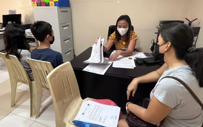 <p><strong>TRAVEL CLEARANCE.</strong> A social worker interviews a boy and his parent applying for a travel clearance for the minor's travel abroad in this undated photo. Department of Social Welfare and Development 7 (Central Visayas) Director Shalaine Marie Lucero on Friday (Jan. 20, 2023) advised parents or guardians to apply for travel clearance for their children a month before the scheduled trip to avoid inconvenience. <em>(Photo courtesy of DSWD-7)</em></p>