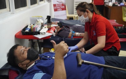 <p><strong>BLOODLETTING</strong> A man makes a thumbs-up sign while a Philippine Red Cross (PRC) staff worker collects his blood during a bloodletting activity at the Philippine Charity Sweepstakes Office (PCSO) Head Office, Shaw Blvd, Mandaluyong City on Jan. 20. The PCSO is a longtime member of PRC’s Blood Samaritan Program, which helps indigent and charity patients who cannot afford blood processing fees. <em>(Photo courtesy of PRC Facebook page) </em></p>