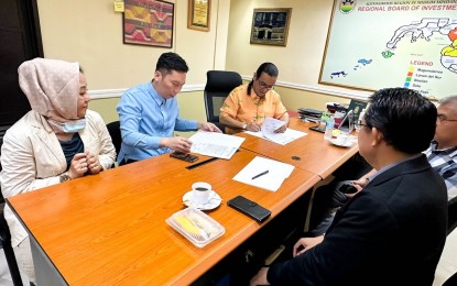 <p><strong>BARMM INVESTMENTS.</strong> Members of Bangsamoro Board of Investments (BBOI), led by chairman Datu Mohammad Omar Pasigan (3rd from left), sign registration documents of three major approved investments to kick off 2023 with PHP475-million investments. The region expects at least PHP2 billion investments for 2023. <em>(BBOI photo)</em></p>