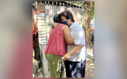 <p><strong>GRIEF.</strong> Department of Migrant Workers Secretary Susan Ople (right) condoles with a relative of Kuwaiti worker Jullebee Ranara at an undisclosed place on Monday (Jan. 23, 2023). Ranara, 35, was found dead in a desert on Sunday (Jan. 22). <em>(Courtesy of DMW)</em></p>