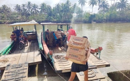 <p><strong>POST-FLOODING AID.</strong> Volunteers load food packs intended for families affected by flooding in Catubig, Northern Samar in this January 21, 2023 photo.  At least 33,117 food packs (FFPs) have been distributed to families in Eastern Visayas badly affected by the recent flooding, the Department of Social Welfare and Development (DSWD) reported on Monday. <em>(Photo courtesy of DSWD Eastern Visayas)</em> </p>