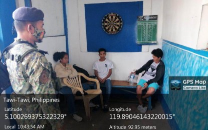 <p><strong>RESCUED.</strong> Authorities rescue seven trafficking in persons victims, including two children, at the port of Bongao town, Tawi-Tawi province, on Sunday (Jan. 22, 2023). The adult victims were allegedly offered high salary to work at a palm oil plantation in Malaysia. <em>(Photo courtesy of Area Police Command-Western Mindanao)</em></p>