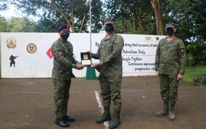 <div><strong>RECOGNITION.</strong> Lt. Col. Agosto Asuncion (left), commander of the Regional Mobile Force Battalion Calabarzon (RMFB 4A), receives a plaque from Brig. Gen. Cerilo Balaoro Jr., 202nd Infantry Brigade commander, in ceremonies at the brigade's headquarters in Cavinti town, Laguna province on Monday (Jan. 23, 2023). The award was given as a testament to their group's remarkable role in the military's successful operations against the communist terrorist group in 2022.<em> (PNA photo by Roselle Aquino)</em></div>