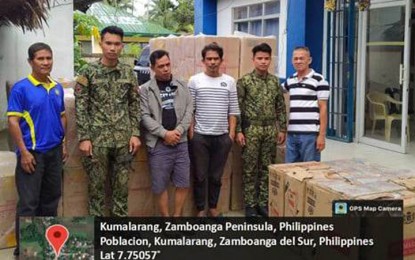 <p><strong>SMUGGLED CIGARETTES.</strong> Police officers manning a checkpoint in the Zamboanga del Sur town of Kumalarang arrest two suspects (3rd and 4th from left) and seize some PHP1.6 million worth of smuggled cigarettes on Monday (Jan. 23, 2023). Col. Richard Verceles, operations chief of the Area Police Command-Western Mindanao (APC-WM), says the smuggled cigarettes came from Zamboanga City. <em>(Photo courtesy of APC-WM)</em></p>