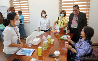 <p><strong>SAMPAGUITA PRODUCTS</strong>. Officials of the Department of Science and Technology (DOST) and the Pampanga State Agricultural University (PSAU) present to Pampanga Vice Governor Lilia Pineda (seated, right) products that can be commercialized using sampaguita flowers on Monday (Jan. 23, 2023). The DOST and PSAU are developing a study and research project that could help boost the province's sampaguita industry. <em>(Photo courtesy of the provincial government of Pampanga)</em></p>