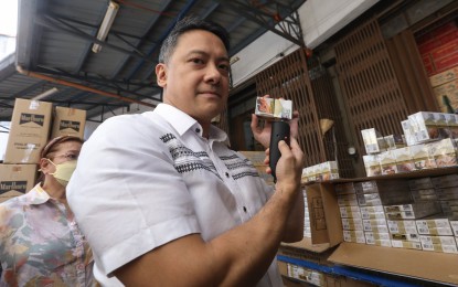 <p><strong>ILLICIT TOBACCO</strong>. Bureau of Internal Revenue (BIR) Commissioner Romeo Lumagui Jr. inspects boxes of fake-brand cigarettes that were seized during a simultaneous raid in Tondo, Manila on Jan. 25, 2023. Lumagui said on Thursday (May 18, 2023) that the BIR would ramp up measures to crack down on illicit tobacco trade in the country. <em>(PNA photo by Yancy Lim)</em></p>