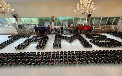 <p><strong>AID FOR FLOOD VICTIMS</strong>. Pails containing relief goods form the name of the group of Mindoro natives that distributed aid to flood victims in Naujan, Oriental Mindoro province. TAMS or The Association of Mindoreños launched the relief operation on Wednesday (Jan. 25, 2023).<em> (Photo by Maria Tividad)</em></p>