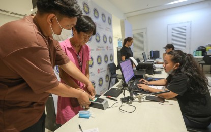 <p><strong>VOTER SIGN-UP.</strong> An elderly woman is assisted by Commission on Elections (Comelec) personnel in having her biometrics data taken at a voter registration hub inside a mall in Binondo, Manila on Thursday (Jan. 26, 2023). The poll body earlier said it has reached its target of at least 1.5 million new voters for this year's Barangay and Sangguniang Kabataan Elections. <em>(PNA photo by Yancy Lim)</em></p>