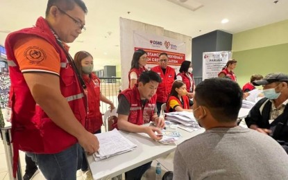 <p><strong>FINANCIAL ASSISTANCE.</strong> Department of Social Welfare and Development (DSWD) Officer-in-Charge Eduardo Punay (middle) facilitates the distribution of financial assistance to residents affected by the flooding caused by a low-pressure area in the town of Sibuco, Zamboanga del Norte province on Wednesday (Jan. 25, 2023). The DSWD has so far provided more than PHP66.8 million worth of assistance to local government units (LGUs) affected by bad weather since Jan. 2. <em>(Photo courtesy of DSWD)</em></p>