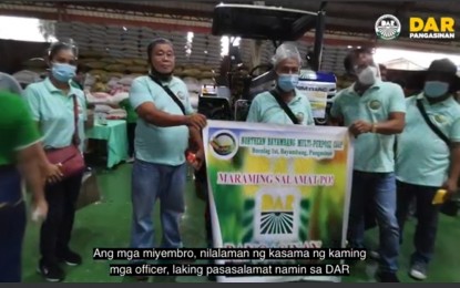 <p><strong>AGRI-ENTREPRENEURSHIP</strong>. Members of the Northern Bayambang Multi-purpose Cooperative pose in front of the tractor given by the Department of Agrarian Reform (DAR) in 2021. The group currently has a new venture with Jollibee Group Foundation through the assistance of DAR. <em>(File photo courtesy of DAR Pangasinan)</em></p>