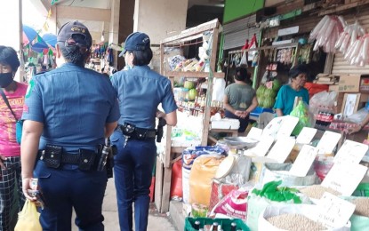 <p><strong>PEACE AND ORDER.</strong> Bais City Police Station personnel visit establishments at the Bais City market in Negros Oriental on Jan. 17, 2023. Aside from public safety, the police said minimum health protocols are continually monitored like physical distancing. <em>(Courtesy of BaisEstasyon PCR Facebook)</em></p>