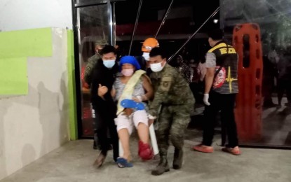 <p><strong>EVACUATED.</strong> Personnel of the Army's 25th Infantry Battalion assist a patient from the Davao de Oro Provincial Hospital, who was being transferred to the Montevista Sports Complex in Montevista, Davao de Oro on Wednesday night (Feb. 1, 2023). The patients were evacuated after a magnitude 6 earthquake jolted the province, with the neighboring New Bataan town as the pinpointed epicenter. <em>(Photo courtesy of 10ID)</em></p>