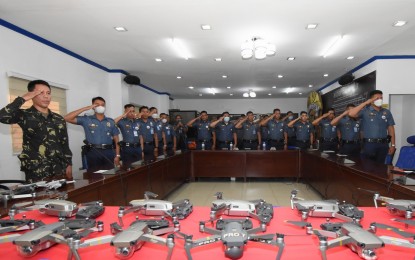 <p><strong>DRONE PATROLLING.</strong> A soldier and members of the Police Regional Office (PRO) 7 (Central Visayas) render a salute during the basic drone operation seminar on Thursday (Feb. 2, 2023). PRO-7 chief, Brig. Gen. Gerry Bearis, said Friday institutionalizing the use of aerial technology would sustain the gains in the fight against criminality. <em>(Photo courtesy of PRO-7)</em></p>