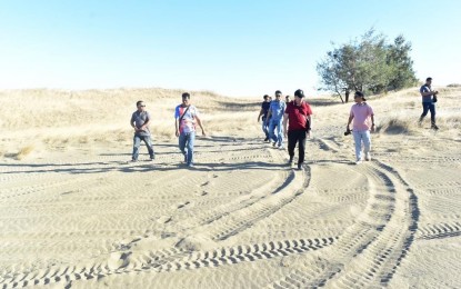 <p><strong>LAOAG SAND DUNES.</strong> Laoag City Mayor Michael Keon (in red) leads the inspection of the terrain of the La Paz sand dunes in this undated photo. The city government will host the 1st Laoag Sand Dunes Challenge on Feb. 25, 2023. <em>(Photo courtesy of the City Government of Laoag)</em></p>