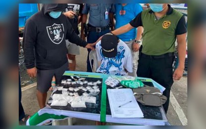 <p><strong>DRUG SUSPECT</strong>. Operatives of the Philippine Drug Enforcement Agency (PDEA) present to the media drug suspect Noel Palacios (seated) who was arrested during a buy-bust Saturday afternoon (Feb. 4, 2023). Palacios yielded 500 grams of suspected shabu worth P3.4 million. <em>(Courtesy of PDEA-Western Visayas)</em></p>