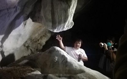 <p><strong>CRYSTAL-WHITE ROCK FORMATIONS</strong>. Former municipal tourism officer Robert Pangod briefs the media about the living stalactites and stalagmites in crystal-white color near the entrance of the Balangagan burial cave in Barangay Takkong in Sagada town on Sunday (Feb. 5, 2023). The municipal government has opened the cave as its newest tourist attraction. <em>(PNA photo by Liza T. Agoot)</em></p>