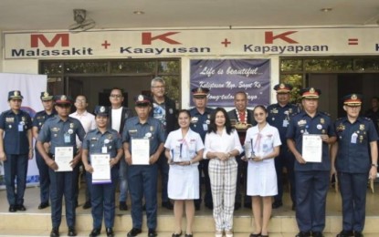 <p><strong>HEROISM</strong>. Angyl Faith Ababat (fourth from left) and Kristianne Joice Ona (third from right), sophomore nursing students at the University of Cebu, pose with their dean Mercy Milagros Apuhin, and other awardees shortly after the flag-raising ceremony at the Cebu City Police Office's headquarters in Camp Sotero Cabahug on Monday (Feb. 6, 2023). Cebu City police director, Col. Ireneo Dalogdog, said they recognized the two students' good deeds in helping a woman injured by her live-in partner to set a good example to the young generation. <em>(Photo courtesy of See Talk CCPO FB)</em></p>