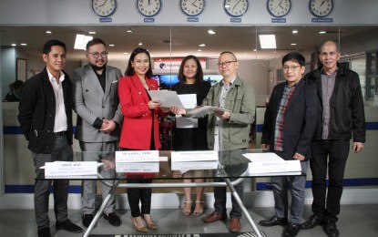 <p><strong>MEDIA PARTNERS.</strong> The Philippine News Agency (PNA) has signed twin agreements for exchange of news and media content with Dubai-based companies New Perspective Media (NPM) Group and The Filipino Times (TFT), the biggest free newspaper in the United Arab Emirates, at the PNA headquarters in Diliman, Quezon City on Jan. 30, 2023. The agreements were signed by Dr. Karen Remo (3rd from left), chief executive officer and founder of NPM Group; Director Raymond Robert Burgos (5th from right) of the News and Information Bureau (NIB) under the Presidential Communications Office; Vince Ang (2nd from left), NPM Group chief operating officer; and PNA Executive Editor Demetrio Pisco Jr.<span class="Apple-converted-space">  </span>(6th from left). It was witnessed by NIB Assistant Director Lee Ann Pattugalan (4th from left); Luis A. Morente (rightmost), PNA Deputy Executive Editor; and Mark Nituma (leftmost), NPM Group country manager and TFT editorial director.</p>
<p><em>(PNA photo by Jess Escaros)</em></p>