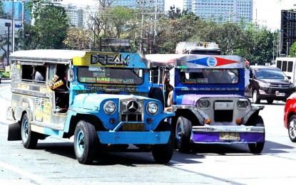 <p><strong>TROUBLED. </strong>Traditional jeepneys traverse Elliptical Road in Quezon City in this undated photo. Operators and drivers are up in arms over the planned phaseout of traditional units, with the Land Transportation Franchising and Regulatory Board setting a June 30, 2023 deadline.<em> (PNA photo by Ben Briones) </em></p>