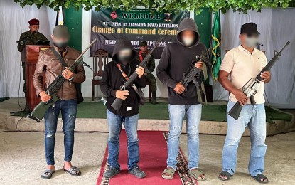 <p><strong>BIFF SURRENDERERS.</strong> Four former Moro extremists show their firearms before formally turning over them to military authorities as they renounce violence in favor of peace. Their surrender took place at the Army’s 92nd Infantry Battalion headquarters in Midsayap town, North Cotabato province on Sunday (Feb. 5, 2023).  <em>(Photo courtesy of MILG-BARMM)</em></p>